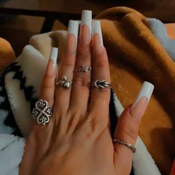 White coffin manicure with decorative rings