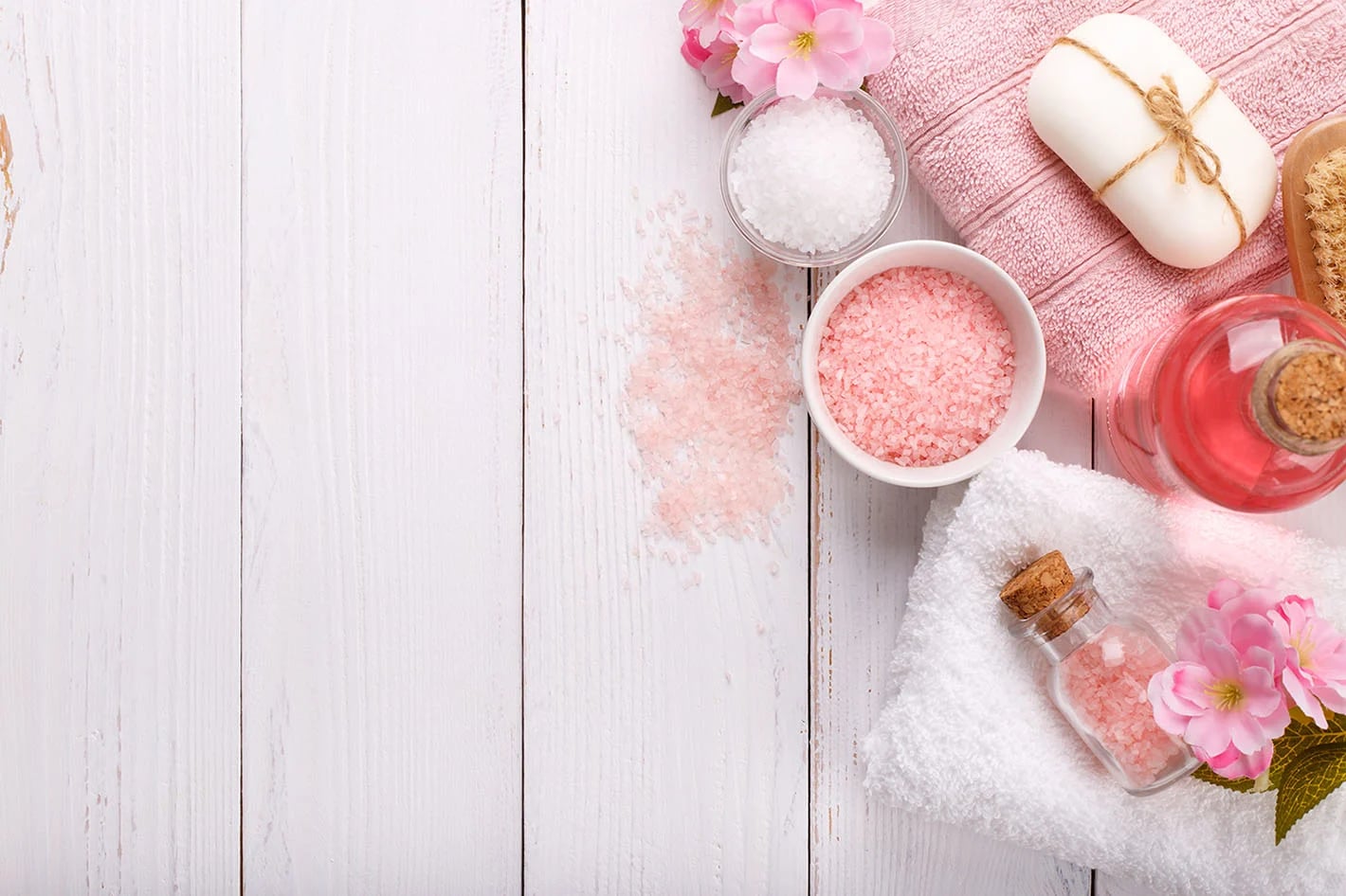 Pink flowers, towels, and spa care essentials
